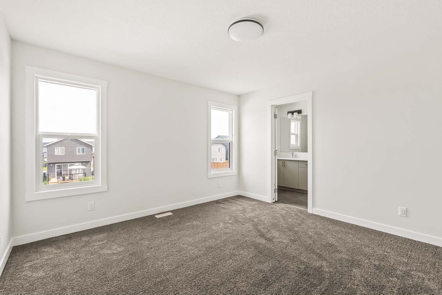 Primary bedroom of quick possession home in Chinook Gate Airdrie