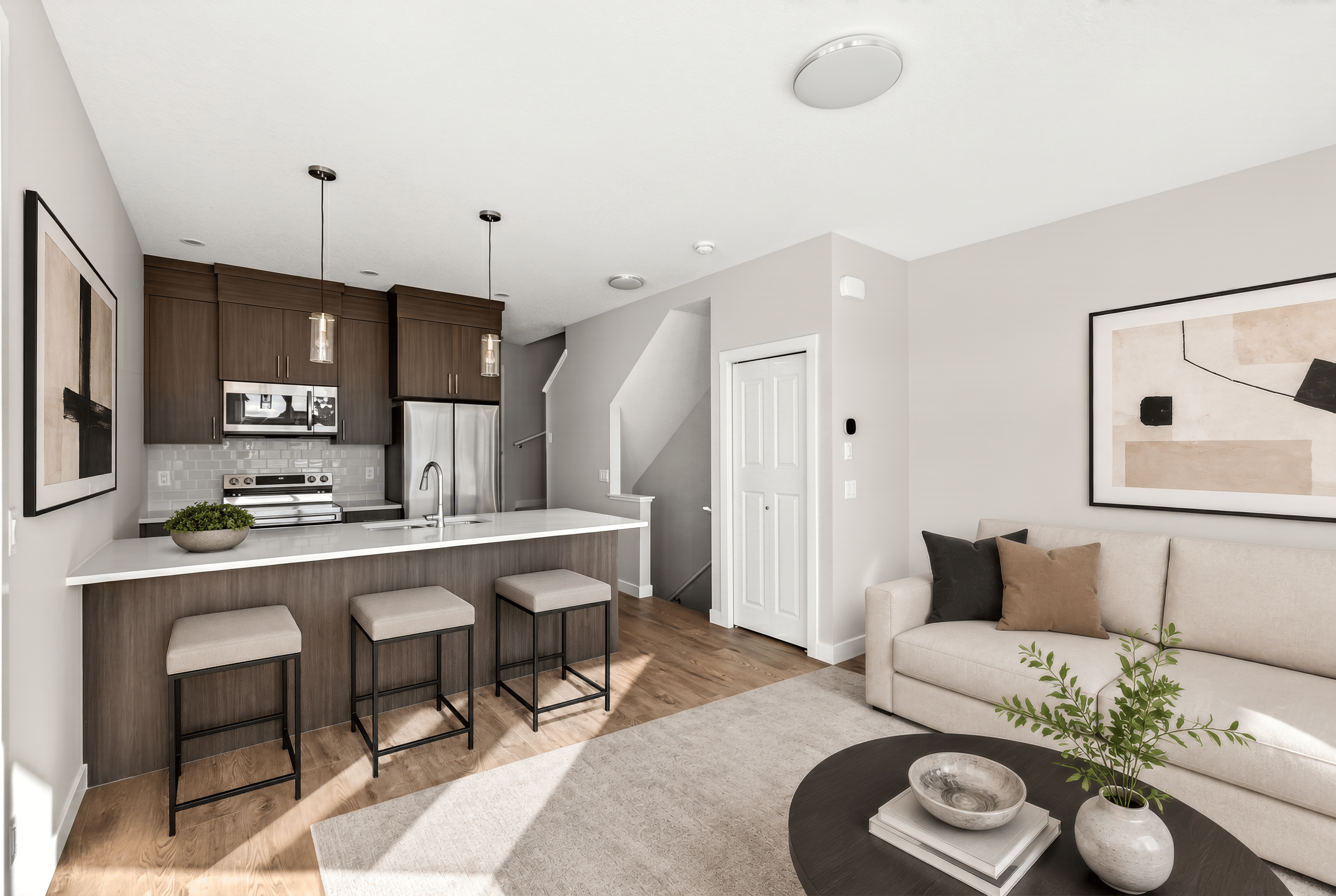A photo of the kitchen and living room of the Fitzgerald townhome model in Calgary by Brookfield Residential