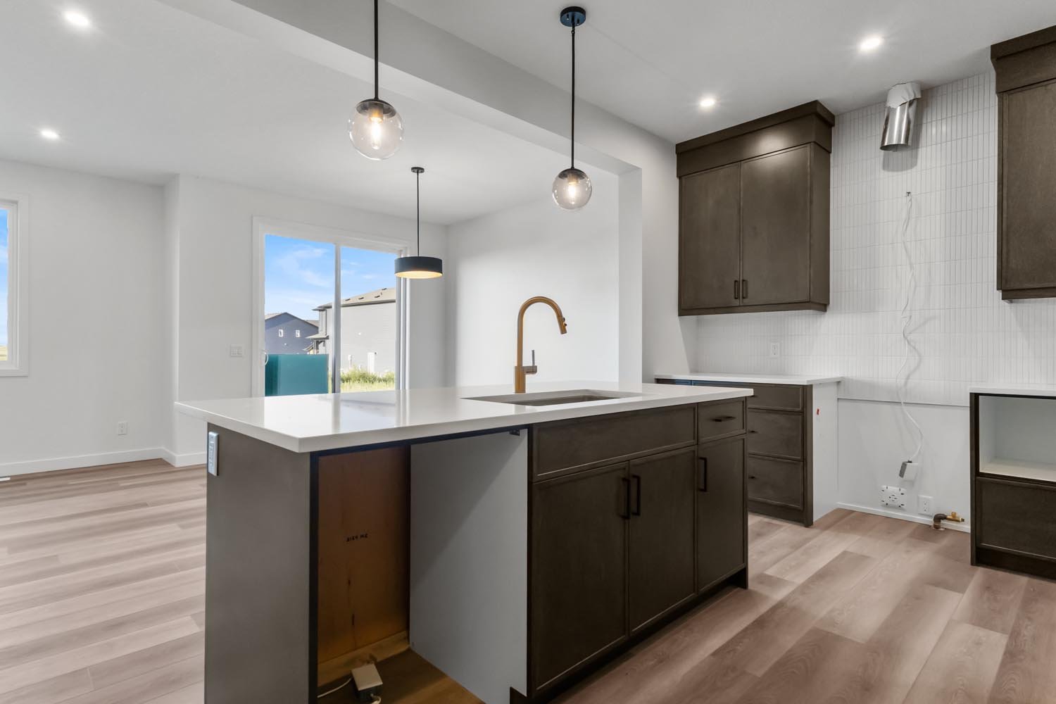 A photo of the front garage quick possession home at 2125 Muckleplum Crescent SW in The Orchards by Brookfield Residential