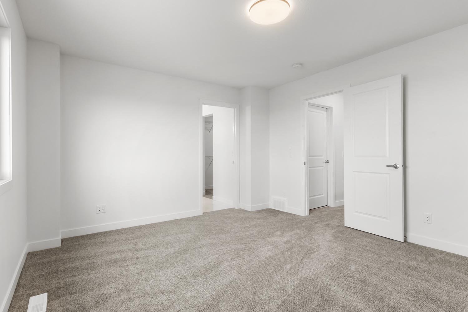 A photo of the front garage quick possession home at 2125 Muckleplum Crescent SW in The Orchards by Brookfield Residential