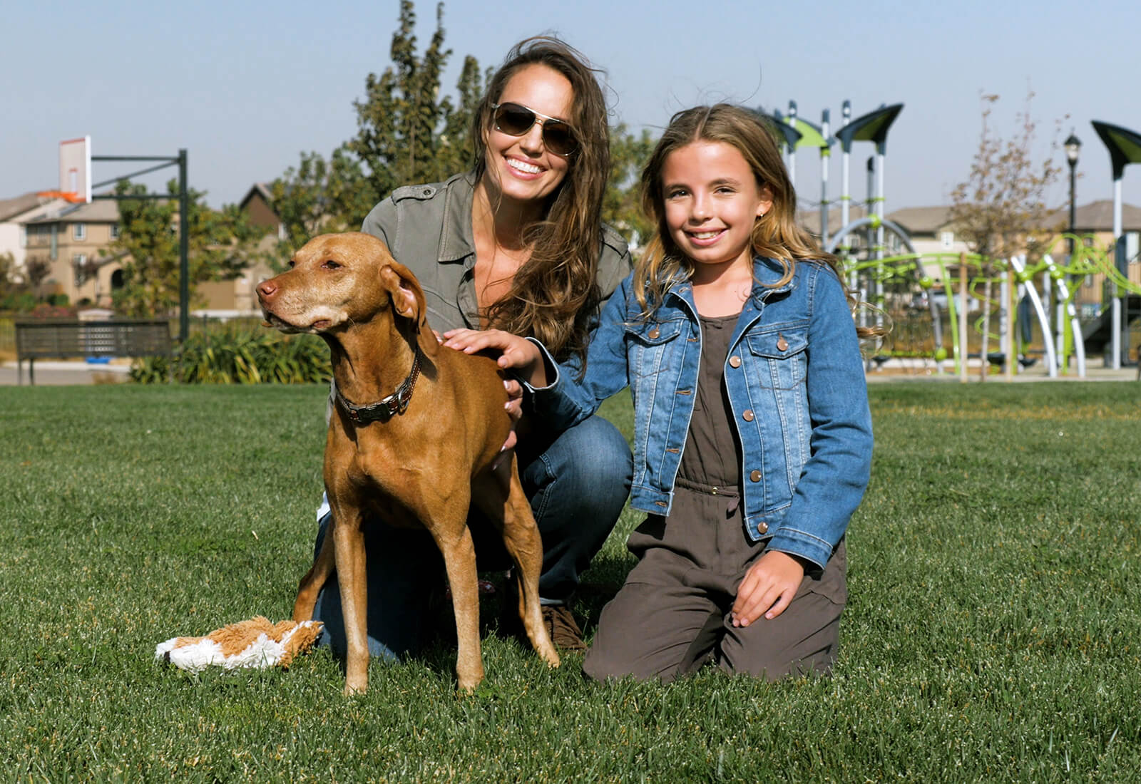 Mother and daughter with their dog at a park at Delaney Park in Oakley, CA