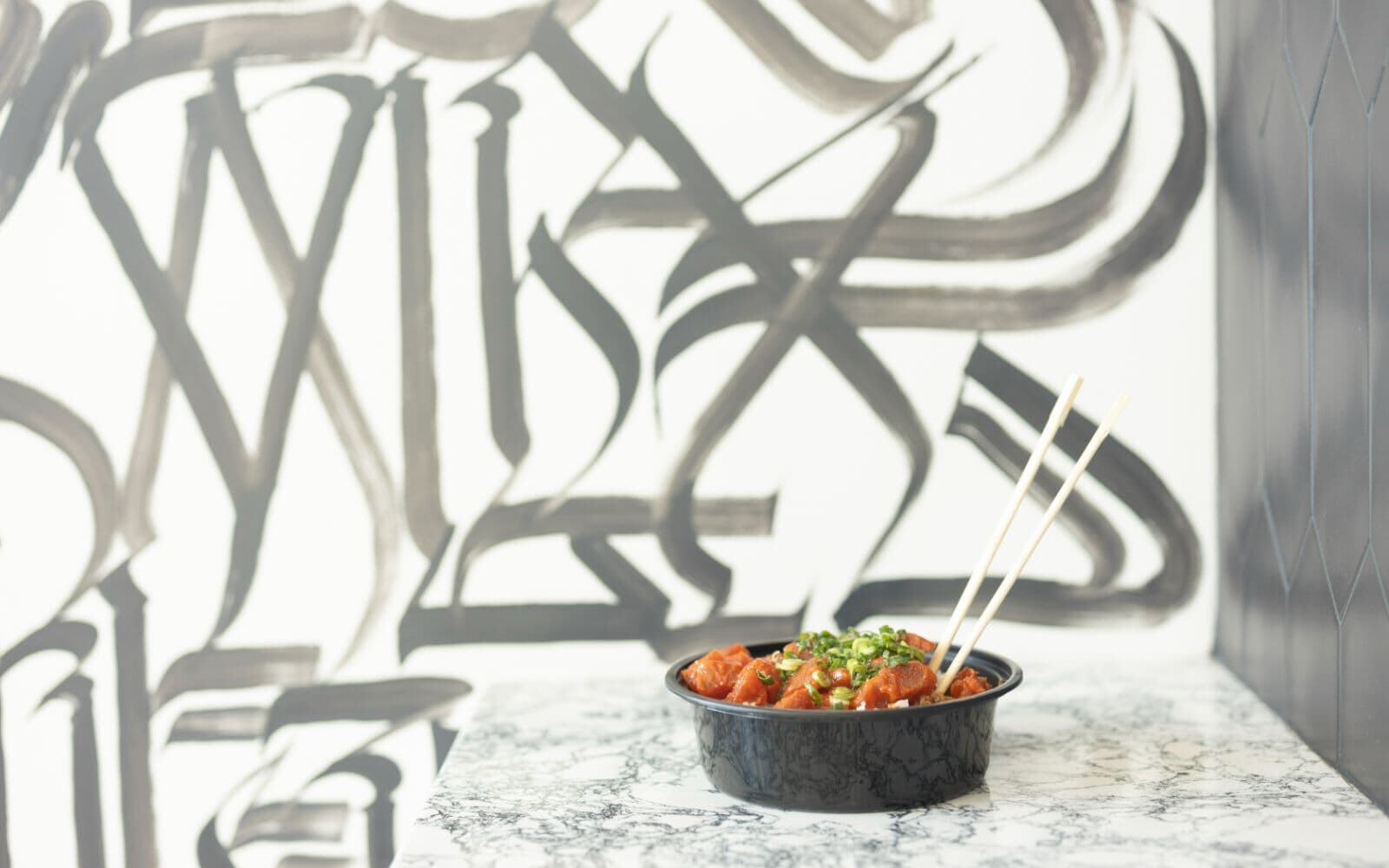 Ramen in front of a graphic wall