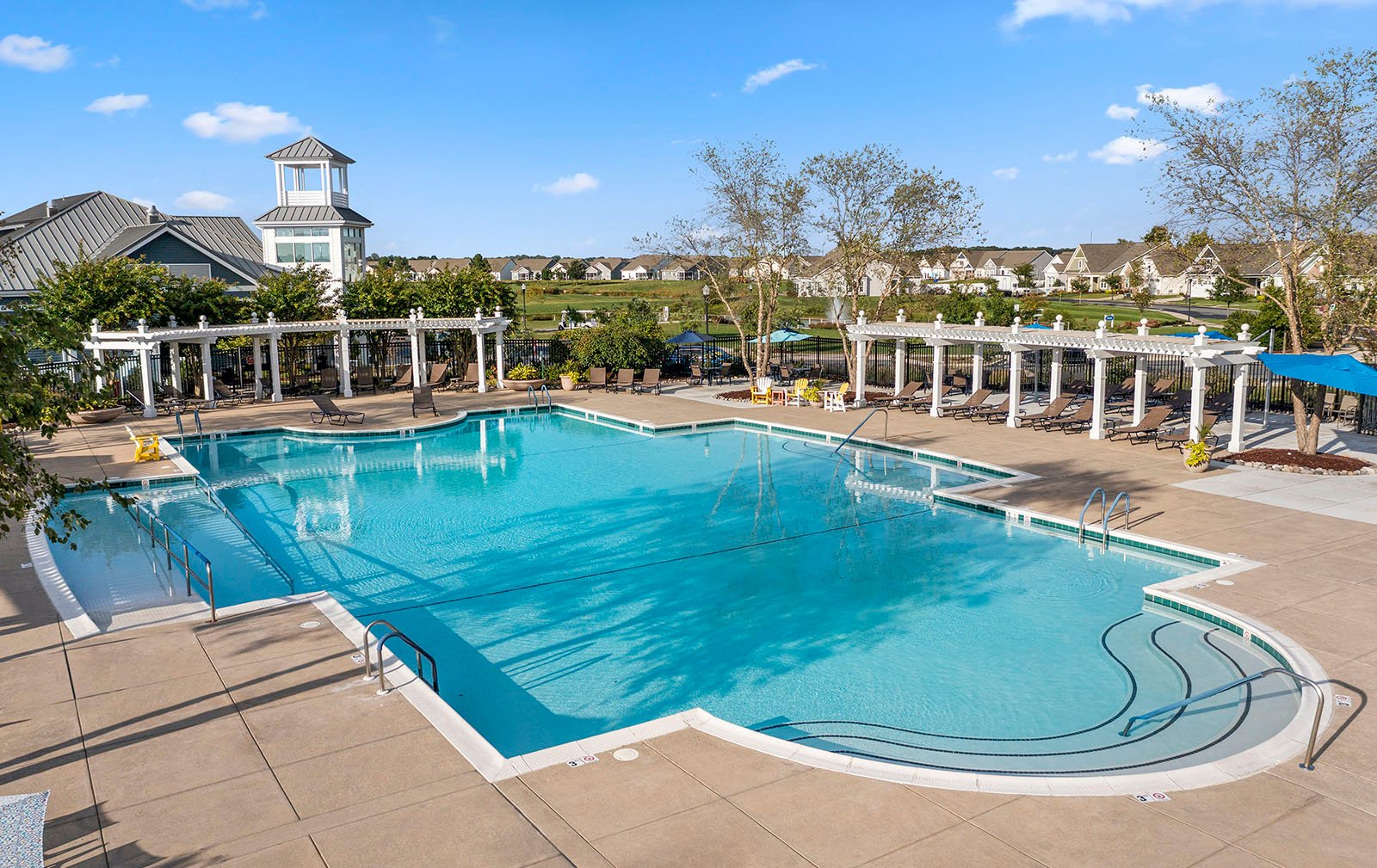 The outdoor pool and patio at Heritage Shores, an active adult community by Brookfield Residential in Bridgeville, DE.