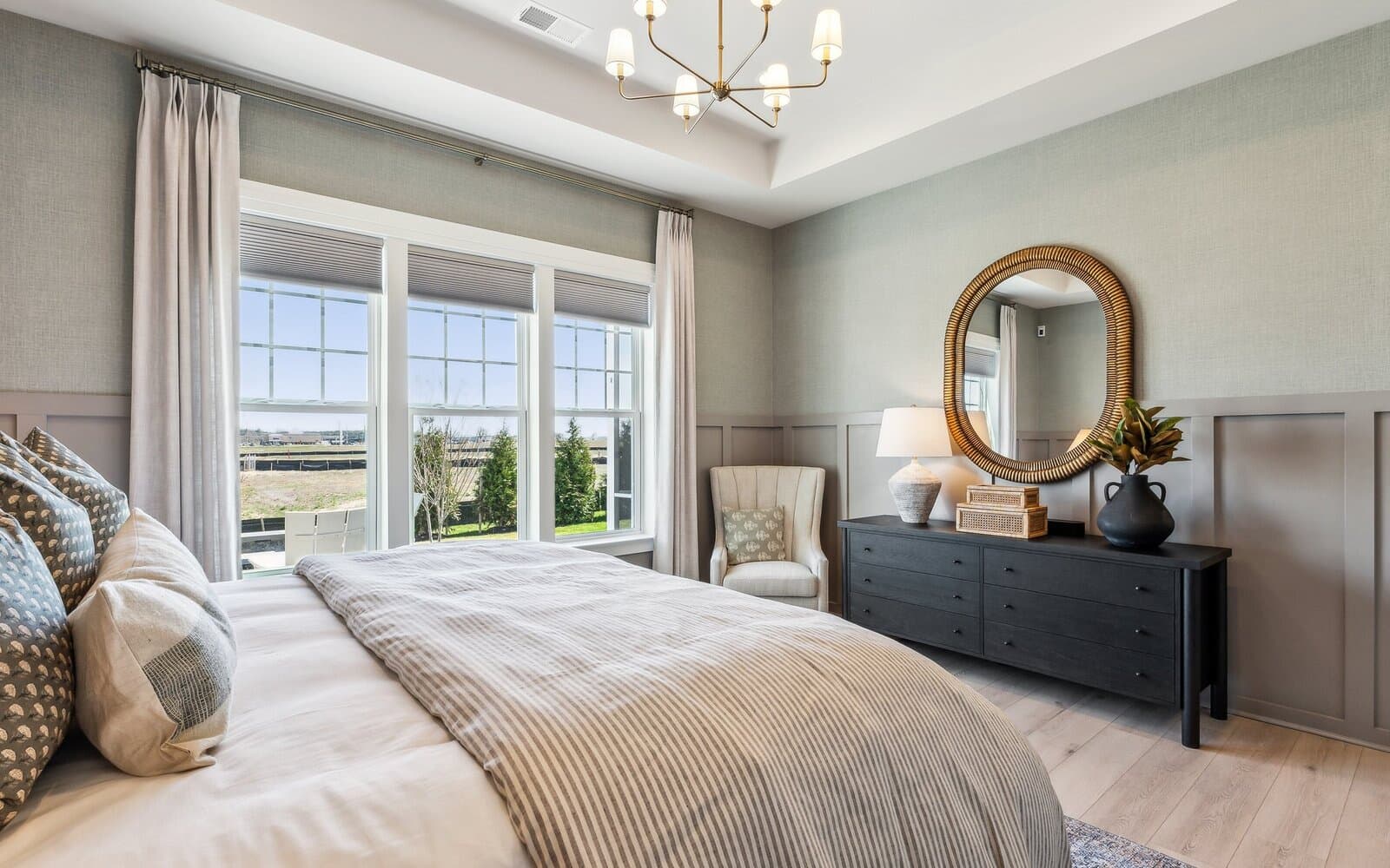 The main level primary bedroom the Quincy II at Heritage Shores by Brookfield Residential.