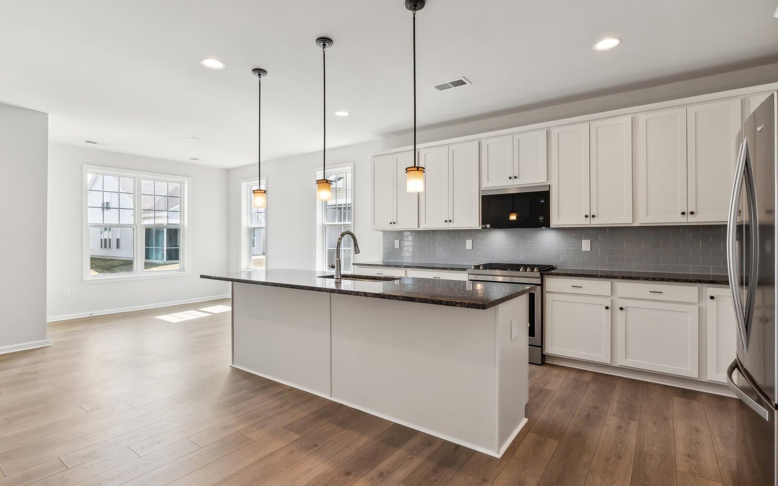 The kitchen and dining room of the Monet on homesite 983 at Heritage Shores by Brookfield Residential.