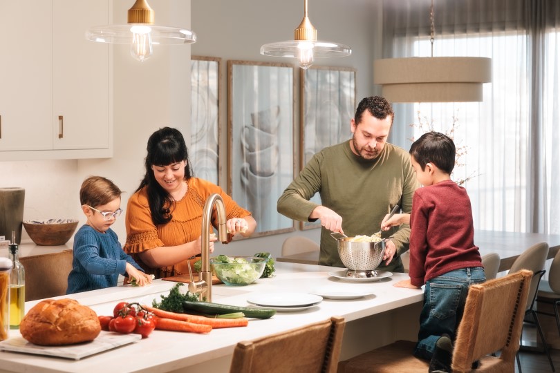 Family prepping dinner together in their Brookfield Residential home kitchen