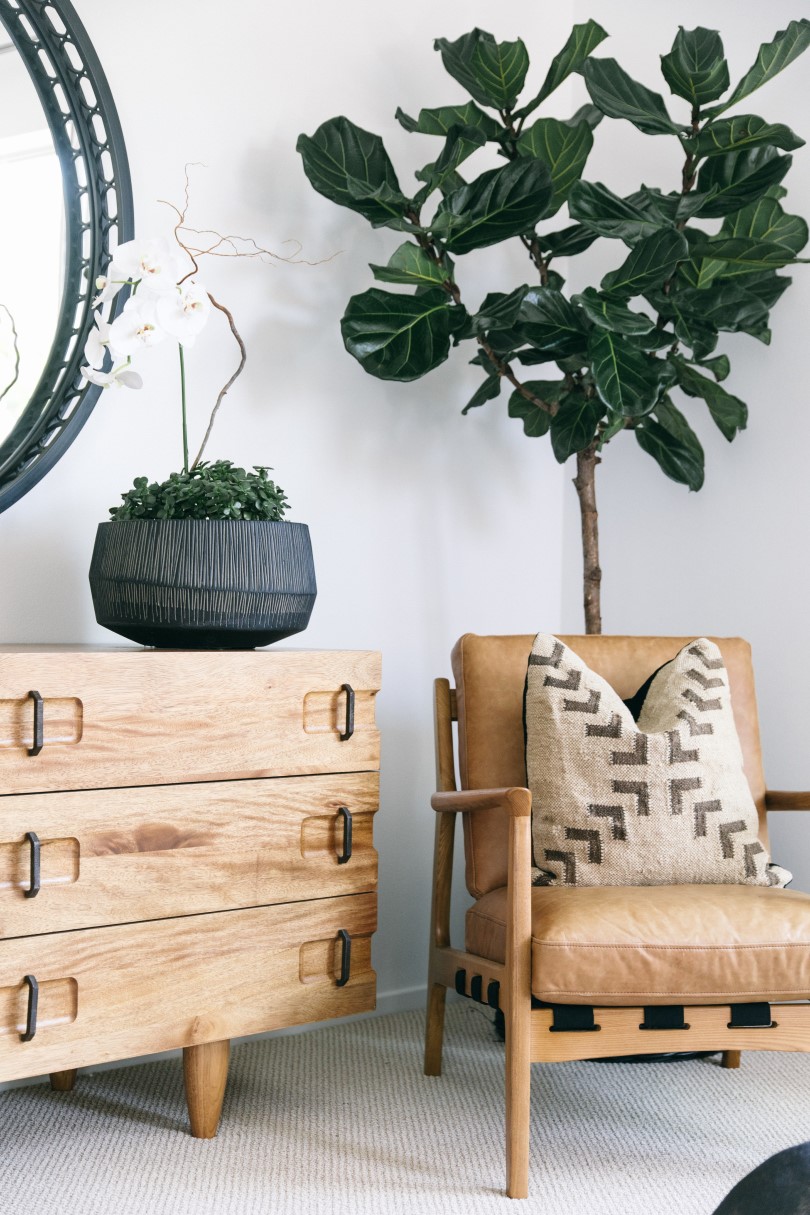 Brown leather chair and natural wood dress in a Brookfield Residential home in Northern California