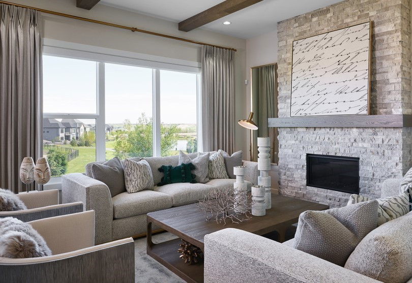 Living room in the Estate Collection at Cranstons Riverstone by Brookfield Residential in Calgary AB