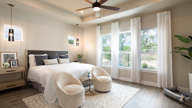 Primary bedroom in the Champlain floor plan at Kissing Tree by Brookfield Residential in San Marcos TX