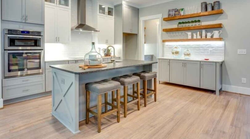 Farmhouse style kitchen with light bamboo wood look flooring