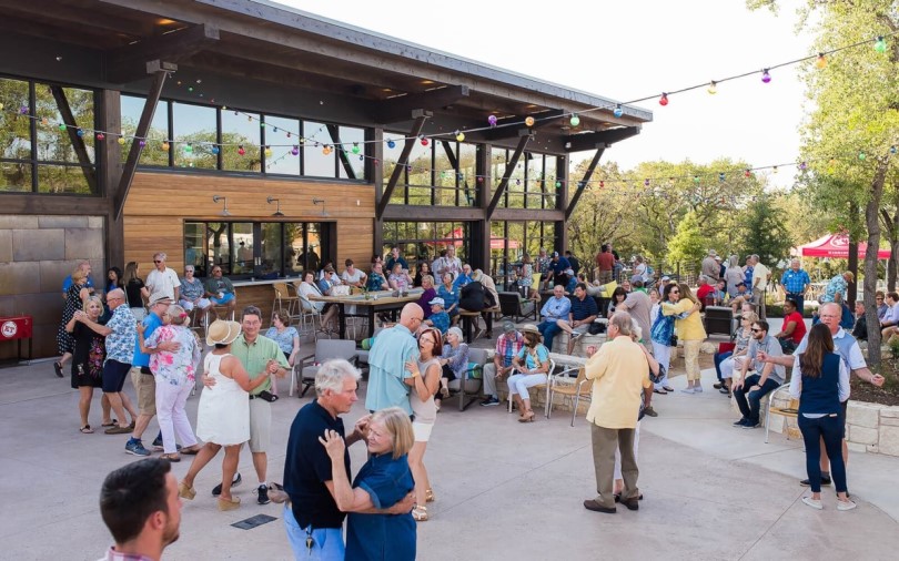 Neighbors dancing and having fun at Kissing Tree by Brookfield Residential in San Marcos TX