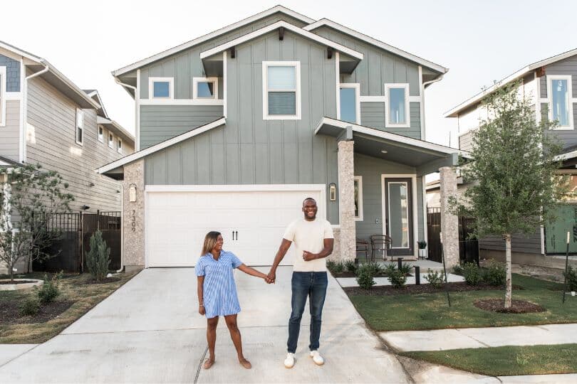 Smiling homeowners in front of a new Brookfield Residential home