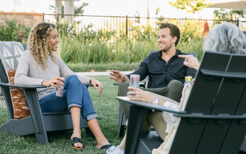 Adults sitting outside enjoying drinks