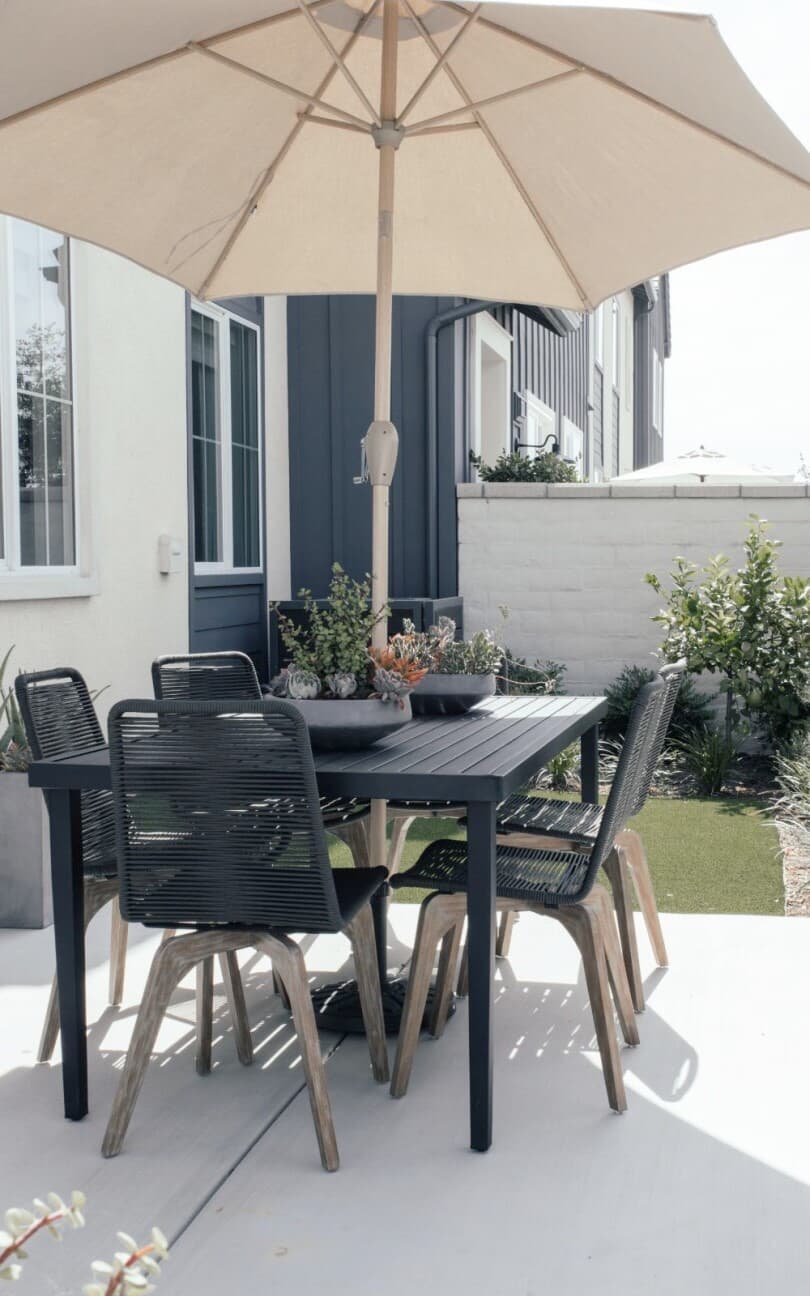 Outdoor dining table and umbrella at Citrus at New Haven by Brookfield Residential in Ontario Ranch CA