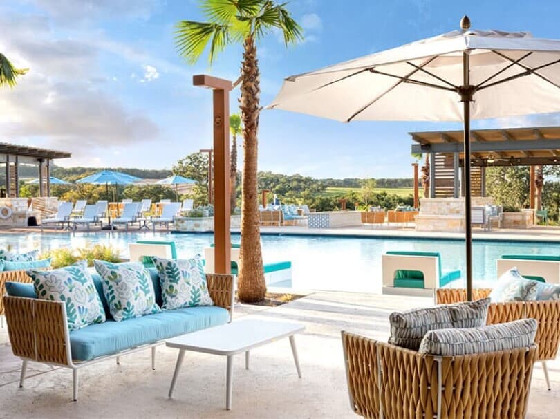 Outdoor seating area and pool at Kissing Tree by Brookfield Residential in San Marcos TX