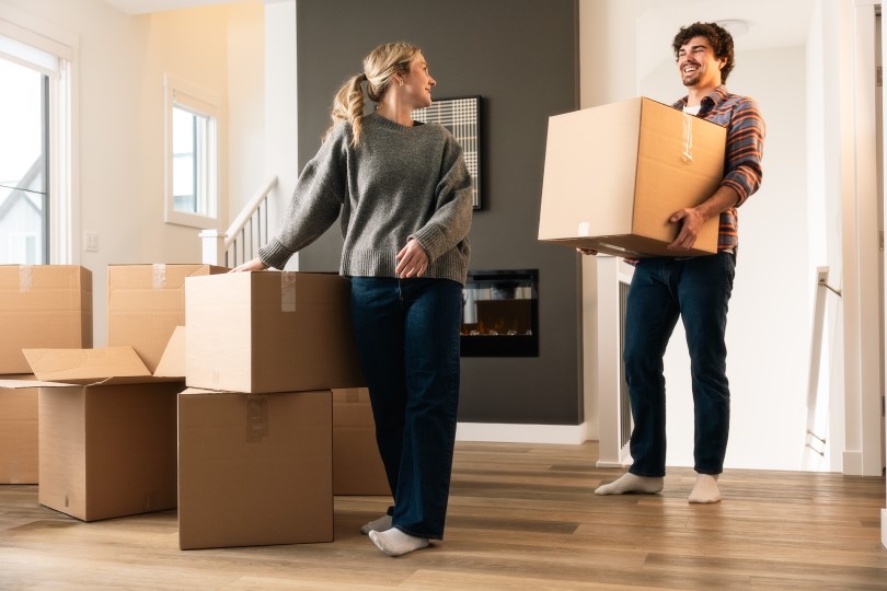 Young couple with boxes moving into their new home