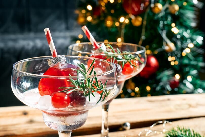 Christmas cocktail with ornaments in a martini glass
