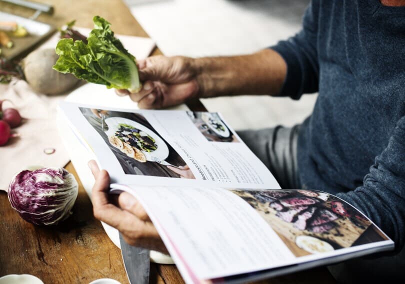 Closeup of hands holding a cookbook