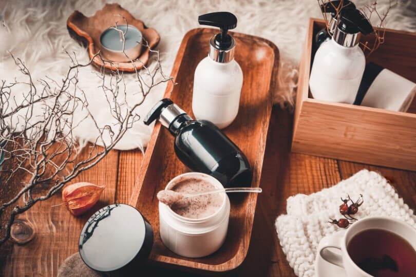 Cosmetic bottles with cosmetics for body care on a wooden table