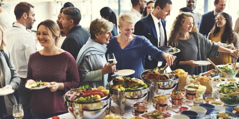 People serving food from a buffet