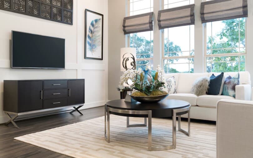 Living area with couches and TV at Cottages at Crystal Falls by Brookfield Residential in Leander TX