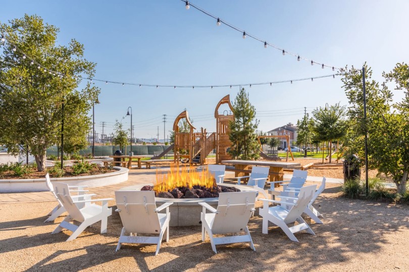 Playground and fire pit at Emerald Park at New Haven in Ontario CA