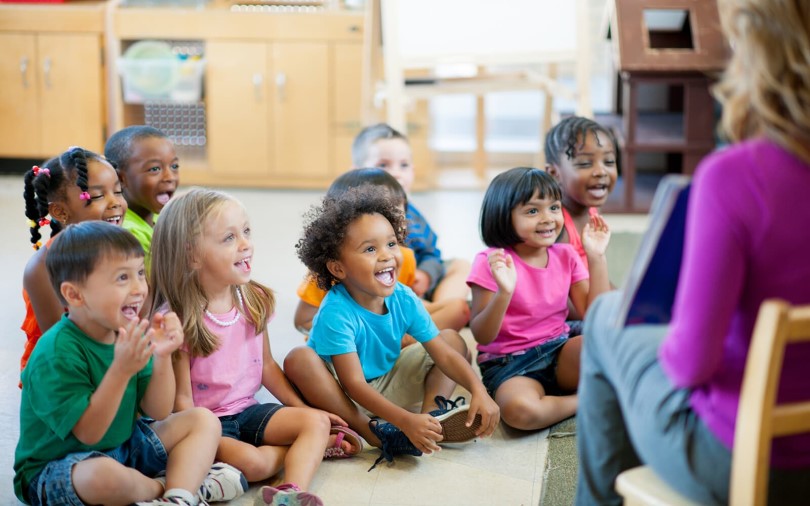 Kids in school sitting in front of a teacher