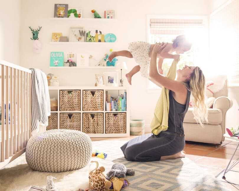 Woman playing with her baby in the nursery of her Brookfield Residential home