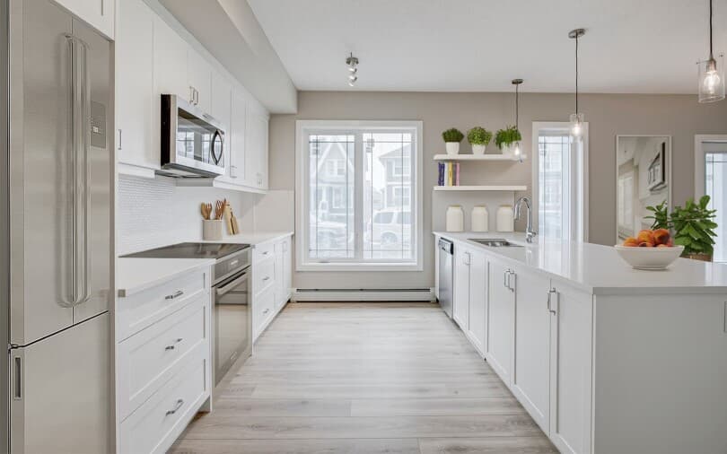 Bright white kitchen in Hillsboro at Regatta at Auburn Bay in Calgary, AB