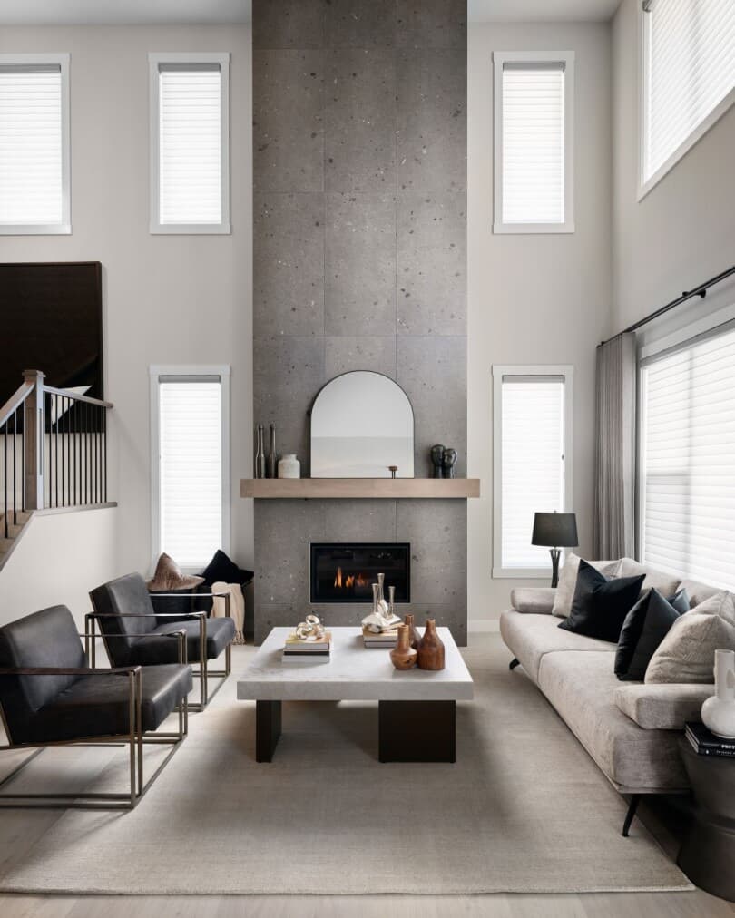Dramatic fireplace in the living room of Savona 2 at Cranstons Riverstone by Brookfield Residential in Calgary