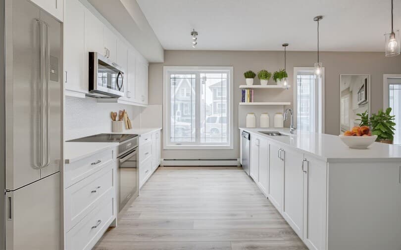 Bright white kitchen in Hillsboro at Regatta at Auburn Bay in Calgary AB
