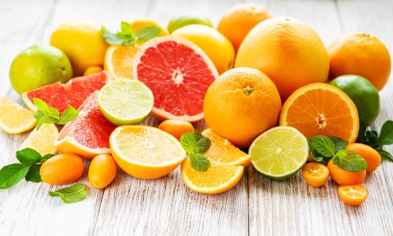 Fresh citrus fruits on a old wooden background