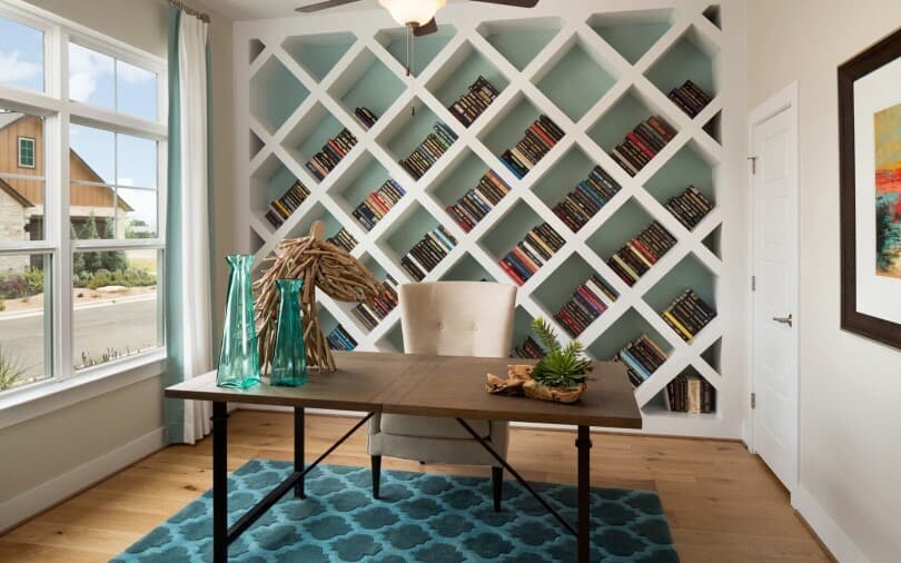 The study with diagonal shelves filled with books at the Retreat at Dripping Springs in Texas