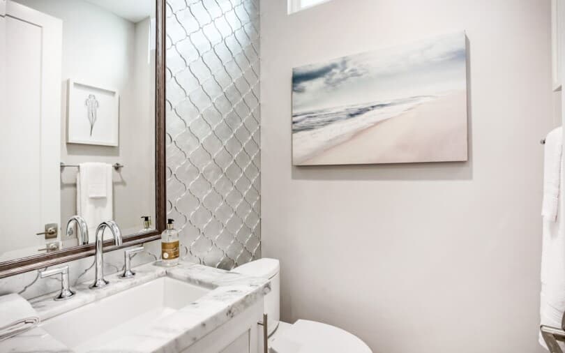 Powder bath with white reflective backsplash in a Brookfield Residential home