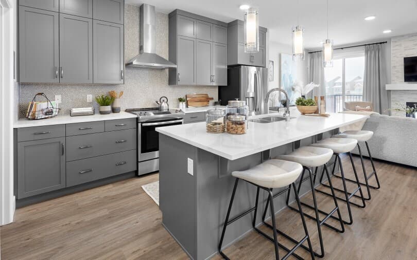Grey tone kitchen with island in Hudson in Edmonton, AB by Brookfield Residential