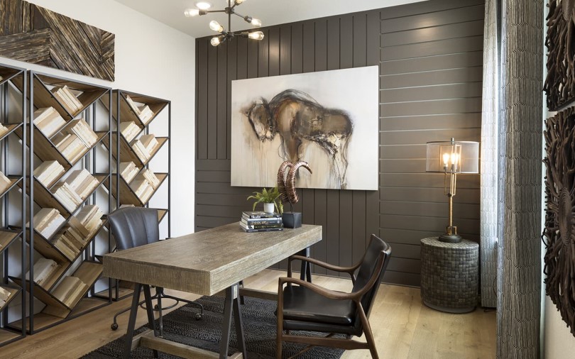 Home office with diagonal shelves filled with books at Provence in Austin, TX