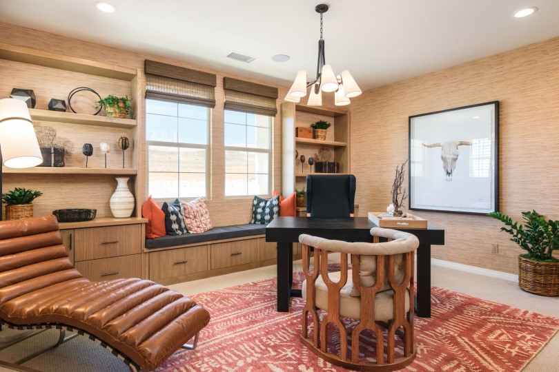 Home office with shelving and a pink rug in the Residence 2 at Escaya in Chula Vista, CA
