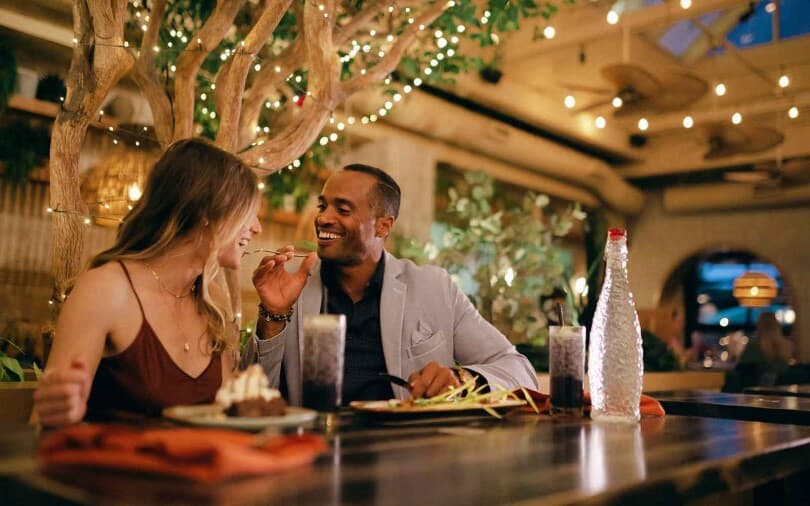 Couple dining at a restaurant near Crown Park by Brookfield Residential in Calgary AB