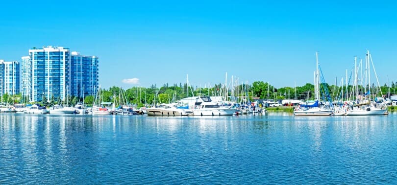 Reflections of a building and boats in the water of the Whitby Marina on Lake Ontario
