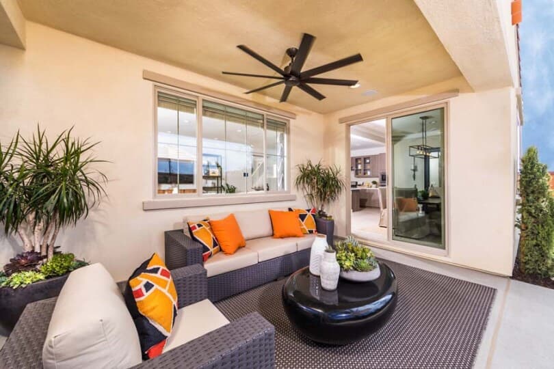 California room with couches and orange pillows in a Brookfield Residential home