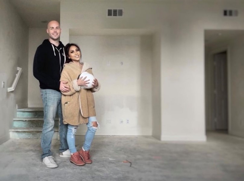 Happy homeowners in the great room of their new Brookfield Residential SoCal home