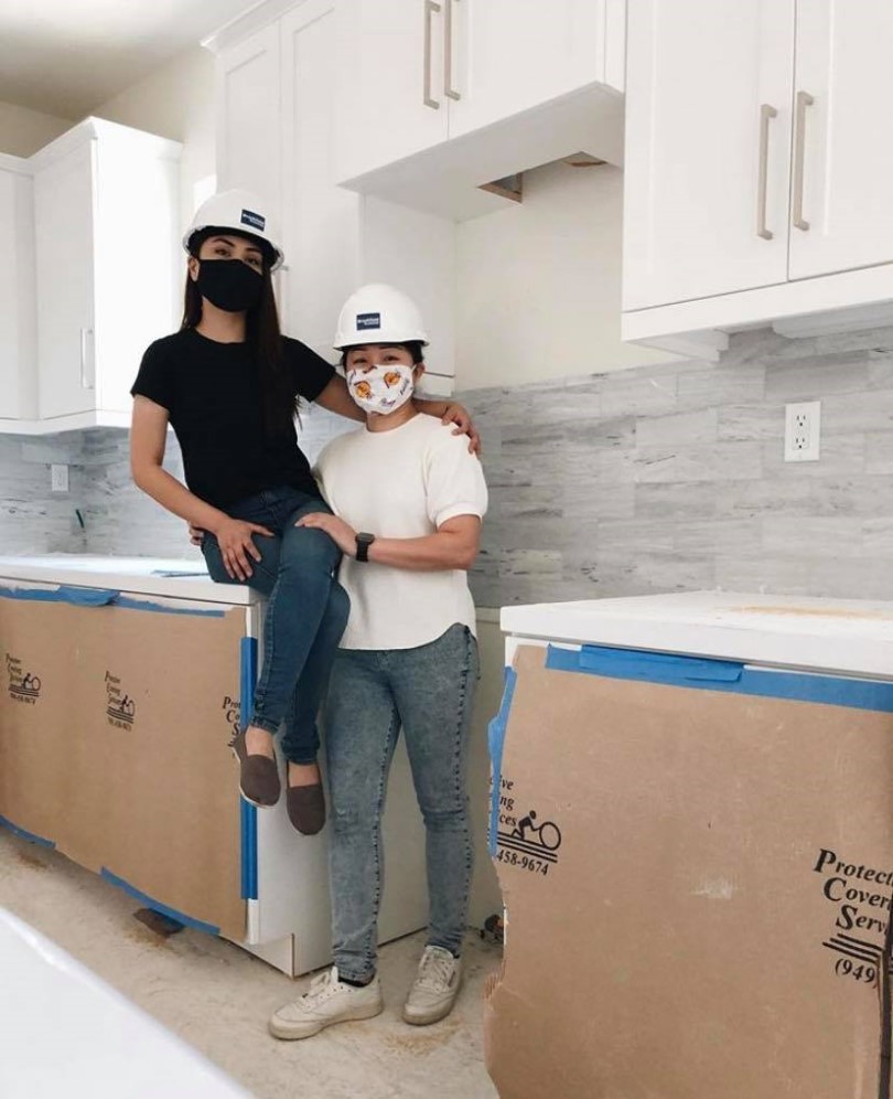 Happy homeowners in the kitchen of their new Brookfield Residential SoCal home