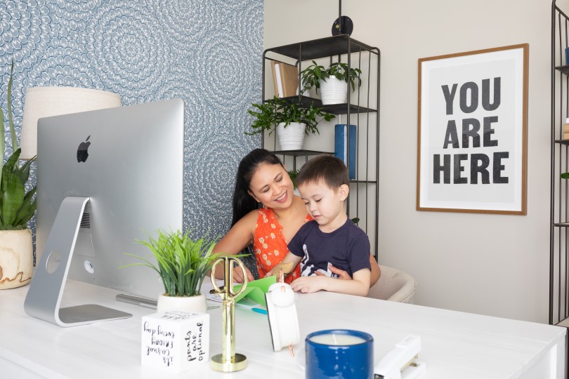 Mom and son working on the computer in the office of their Brookfield Residential SoCal home