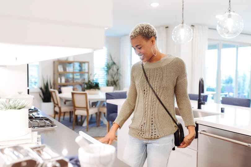 Woman walking through a Brookfield Residential home in Southern California