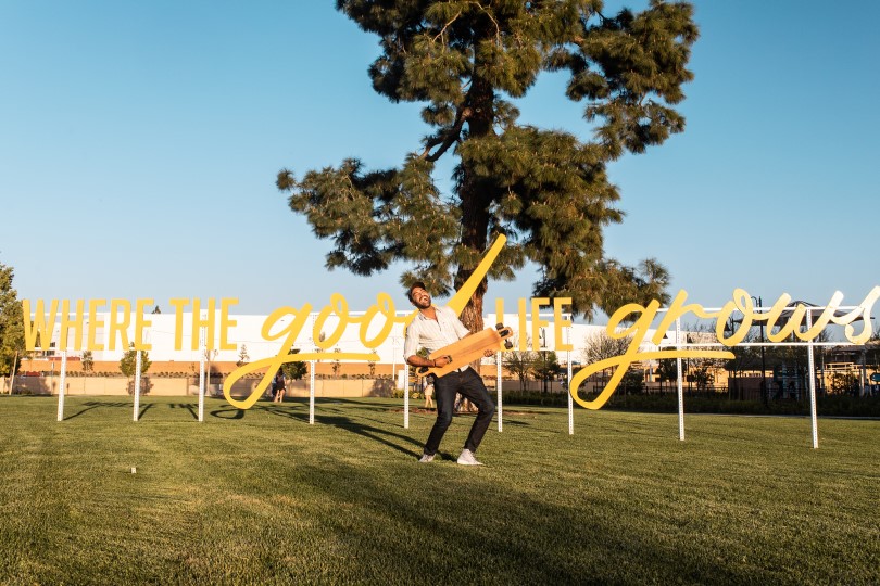 Man in front of signage at The Groves by Brookfield Residential in Whittier, CA
