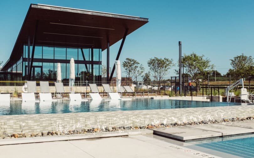 Lounge chairs in the water of the resort style pool at The Union at Easton Park in Austin, TX
