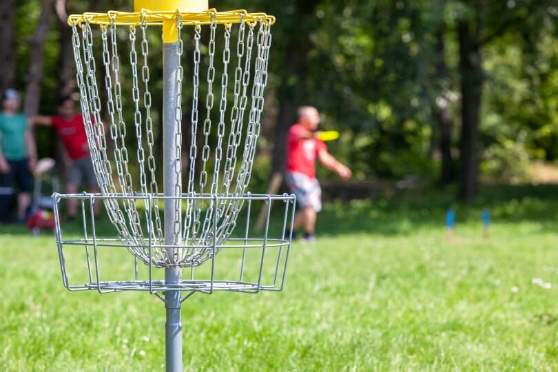 Man playing disc golf in a park