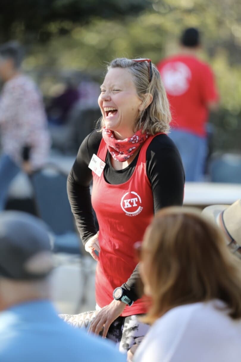 Woman laughing at Camp Kissing Tree by Brookfield Residential in San Marcos, TX