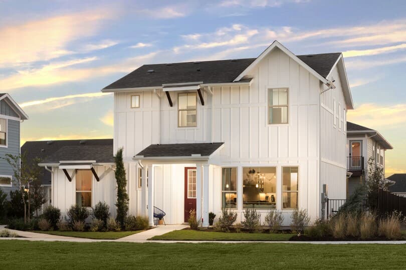 Farmhouse style home at dusk at Easton Park in Austin, TX by Brookfield Residential