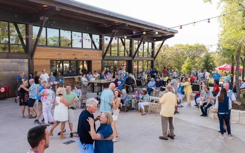 Neighbors dancing and having fun at Kissing Tree by Brookfield Residential in San Marcos TX